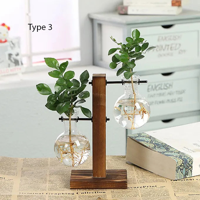 Double Vase tube avec une plante sur une table